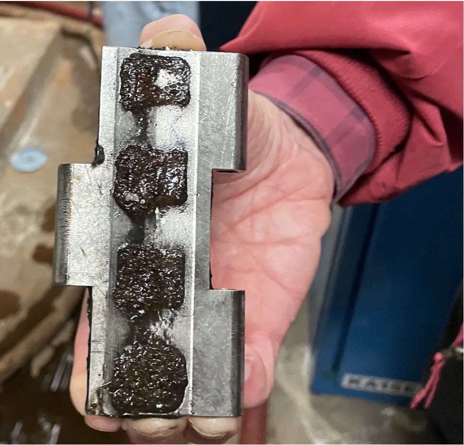 A HydroFlux magnetic link after removal, holding captured iron precipitate